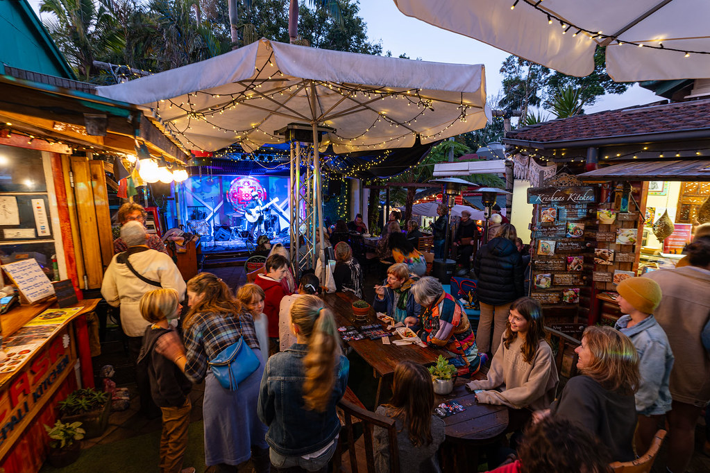 An evening arts festival in Maleny with live music, market stalls and fairy lights
